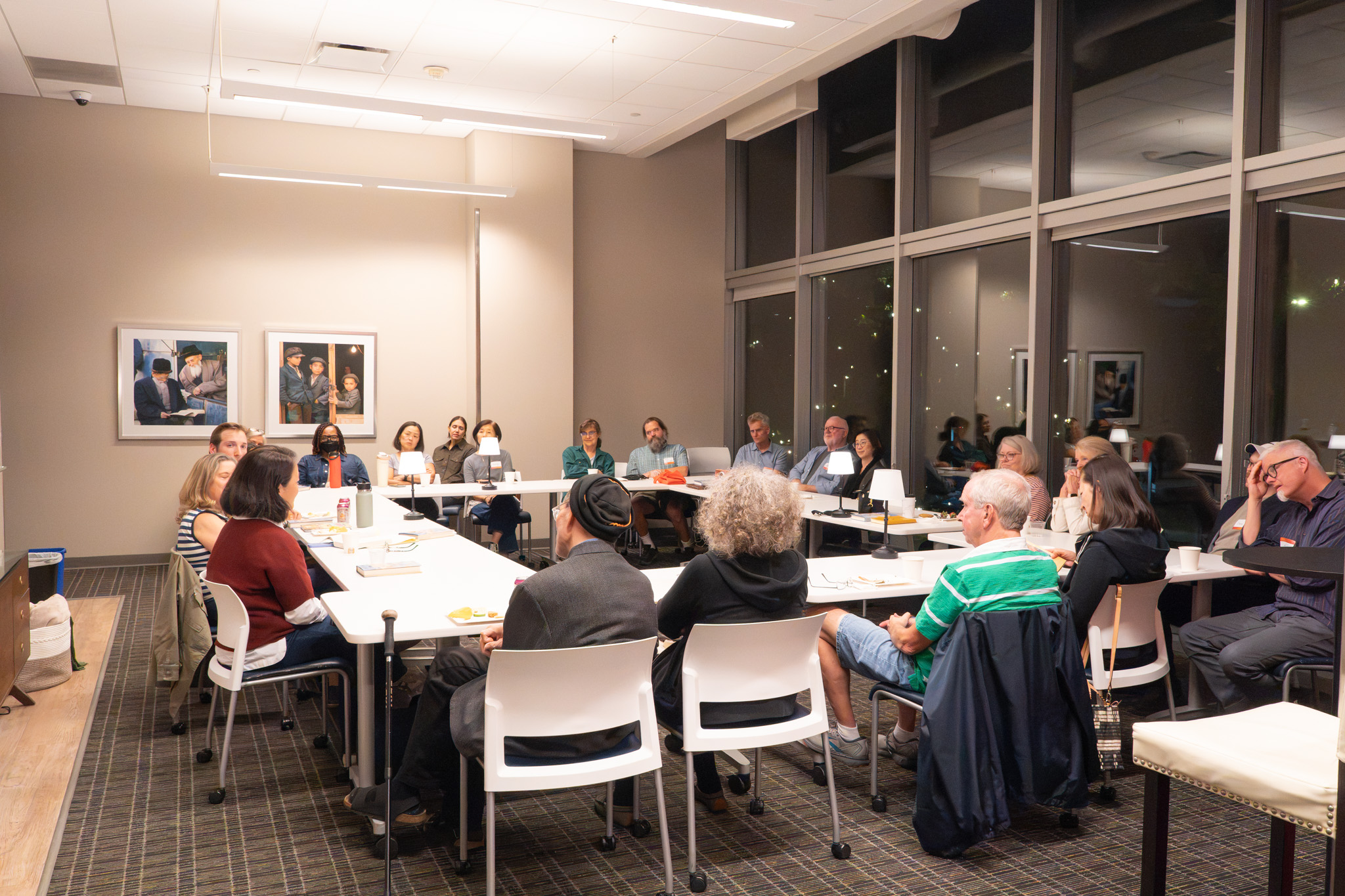 Readers gathered around tables at a Song for Another Home event